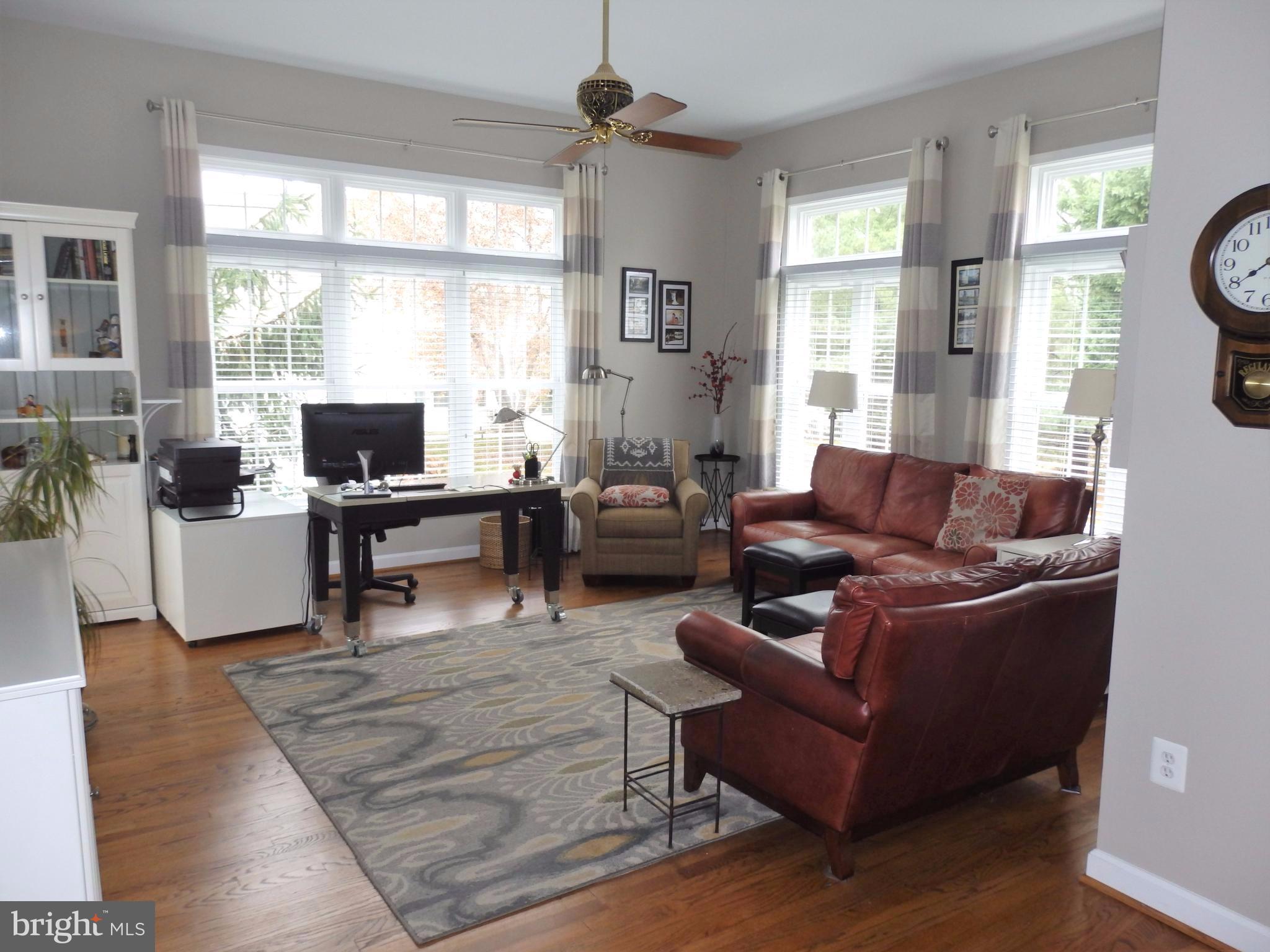 2454 Bear Den Road Frederick, MD 21701 - Photo 11 of 30 a living room with furniture a flat screen tv and a large window