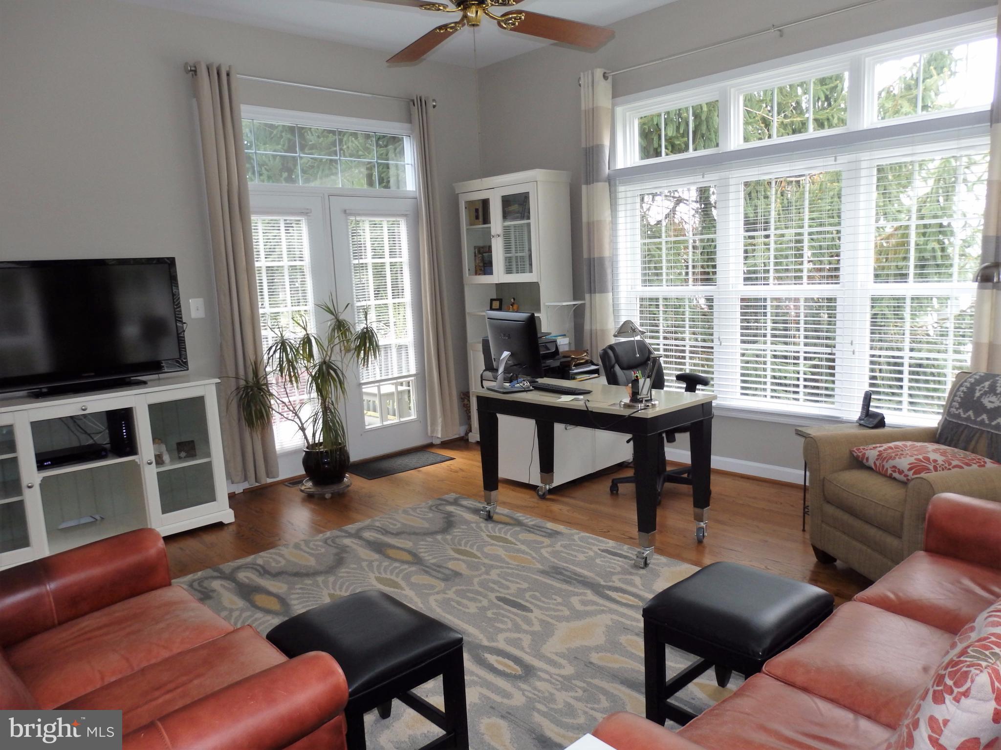 2454 Bear Den Road Frederick, MD 21701 - Photo 12 of 30 a living room with furniture a flat screen tv and a large window