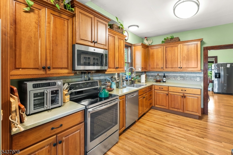 886 Brass Castle Road Belvidere, NJ 07823 - Photo 13 of 44 a kitchen with stainless steel appliances wooden cabinets and a stove top oven