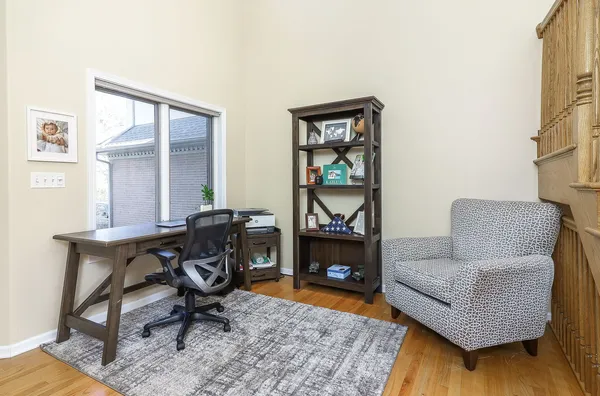 a livingroom with workspace and a couch