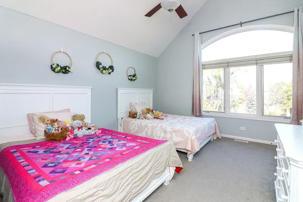 a bedroom with two beds and painting on the wall
