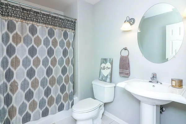 a bathroom with a sink and mirror with toilet