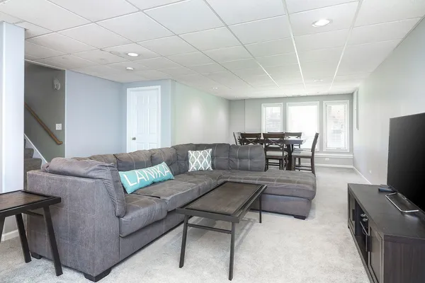 a living room with furniture and a potted plant