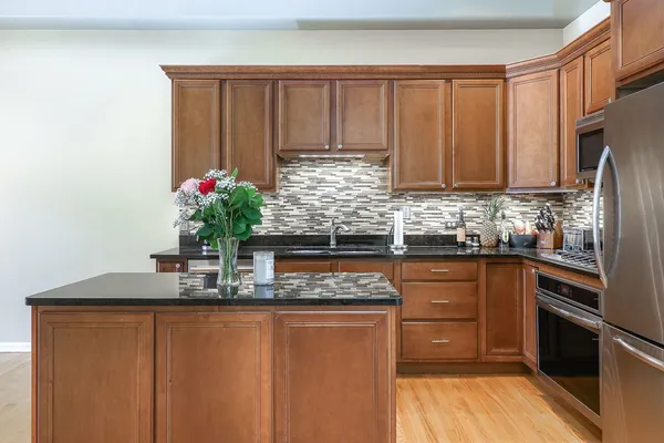 a kitchen with granite countertop cabinets and a refrigerator