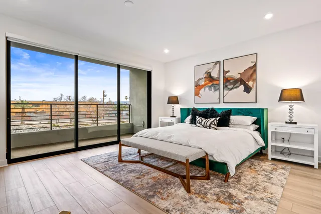 a large bedroom with a large bed and a flat screen tv