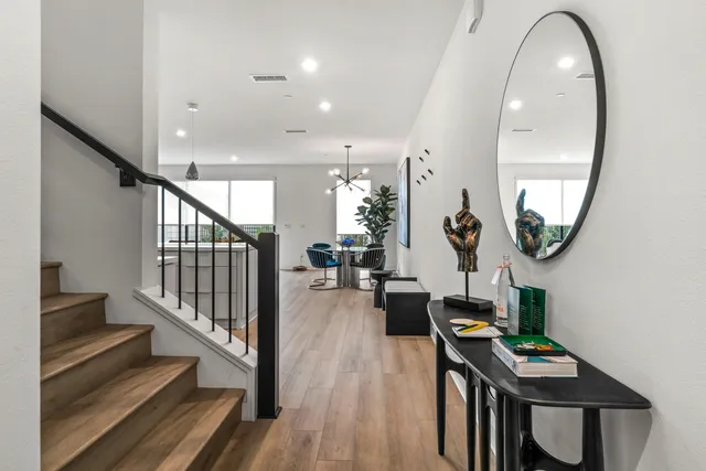 an entryway with wooden floor and a livingroom view