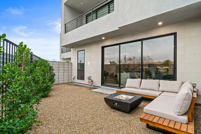 a living room with fireplace furniture and a large window