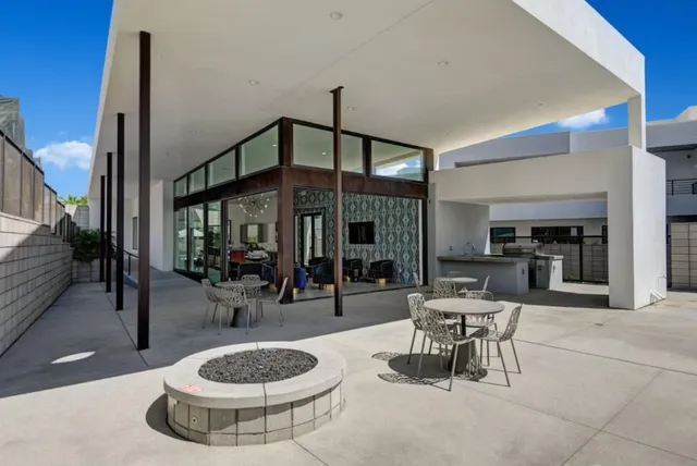 a living room with fireplace furniture and a chandelier