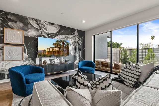 a living room with furniture and a floor to ceiling window