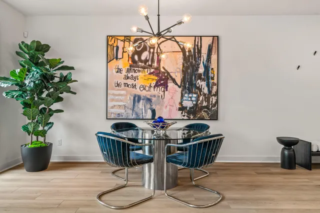 a view of a dining room with furniture wooden floor and chandelier