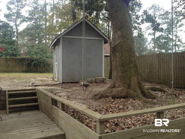 111 Woodside Drive Daphne, AL 36526 - Photo 26 of 31 This large oak tree is perfect for the kids rope swings and host a really nice storage building for the lawn equipment.