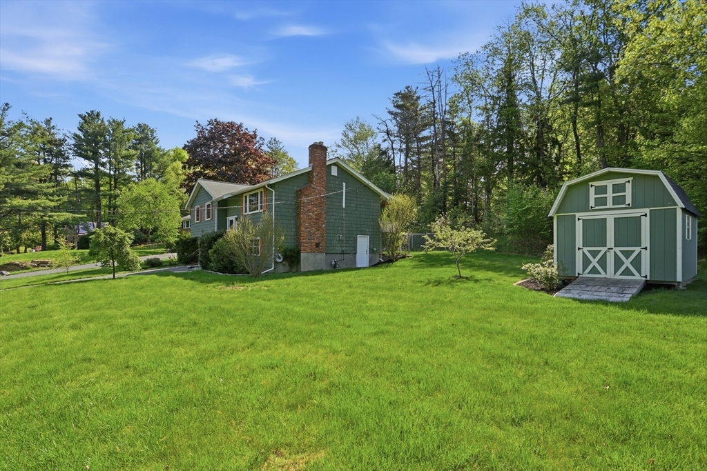 33 Simon Willard Road Acton, MA 01720 - Photo 35 of 42 a view of a house with a big yard and large trees