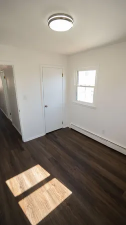 an empty room with wooden floor