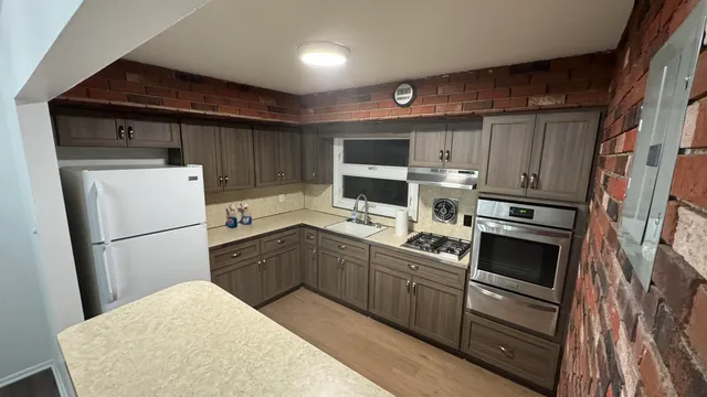 a kitchen with a refrigerator sink and stove top oven