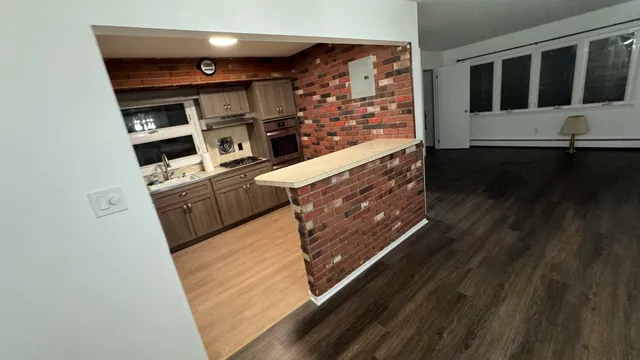 a view of kitchen with wooden floor
