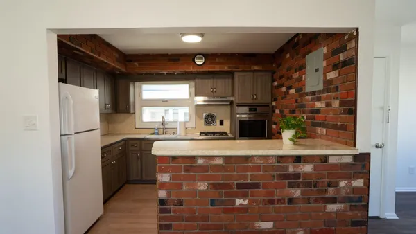 a kitchen with stainless steel appliances a refrigerator and a stove