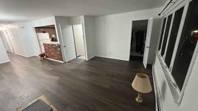 a view of an entryway with wooden floor