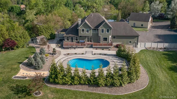 a view of a house with swimming pool and sitting area