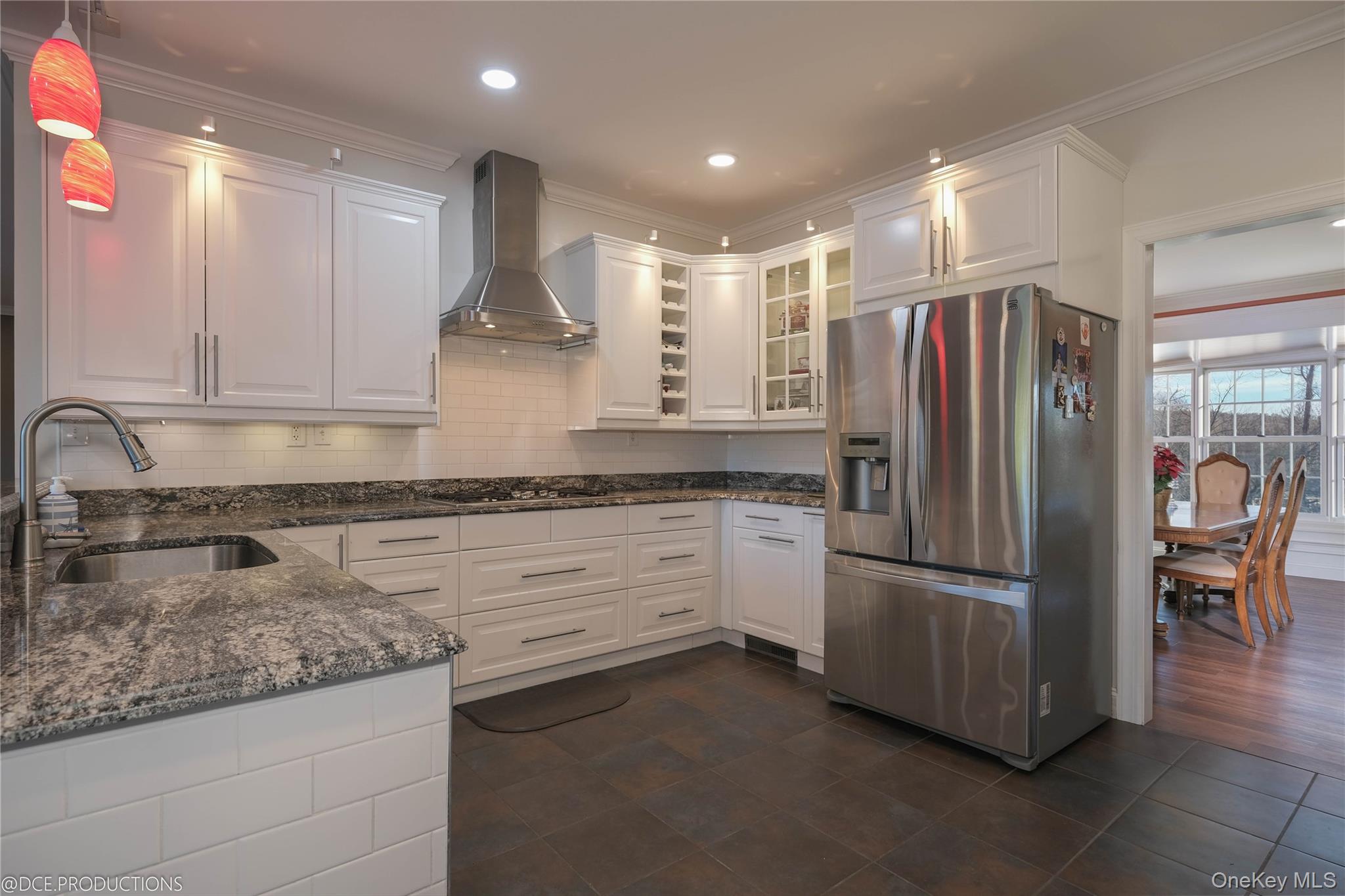 163 Hapeman Hill Road Red Hook, NY 12571 - Photo 17 of 50 Kitchen featuring tile flooring, stainless appliance package, white cabinetry with ample storage and a stylish backsplash.