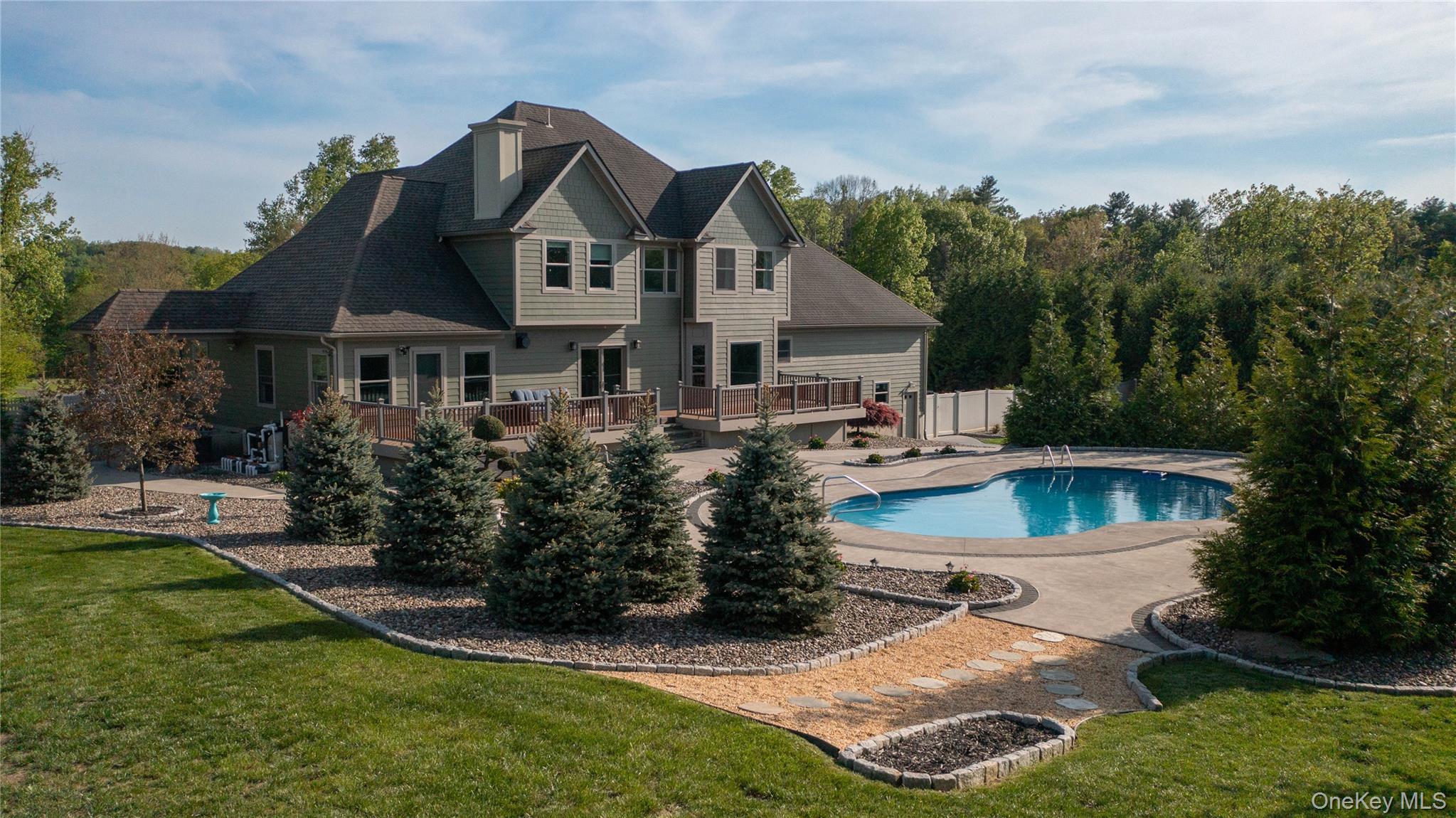 163 Hapeman Hill Road Red Hook, NY 12571 - Photo 2 of 50 A backyard daydream, where a pristine pool and playful pops of luxury invite you to dive right in.