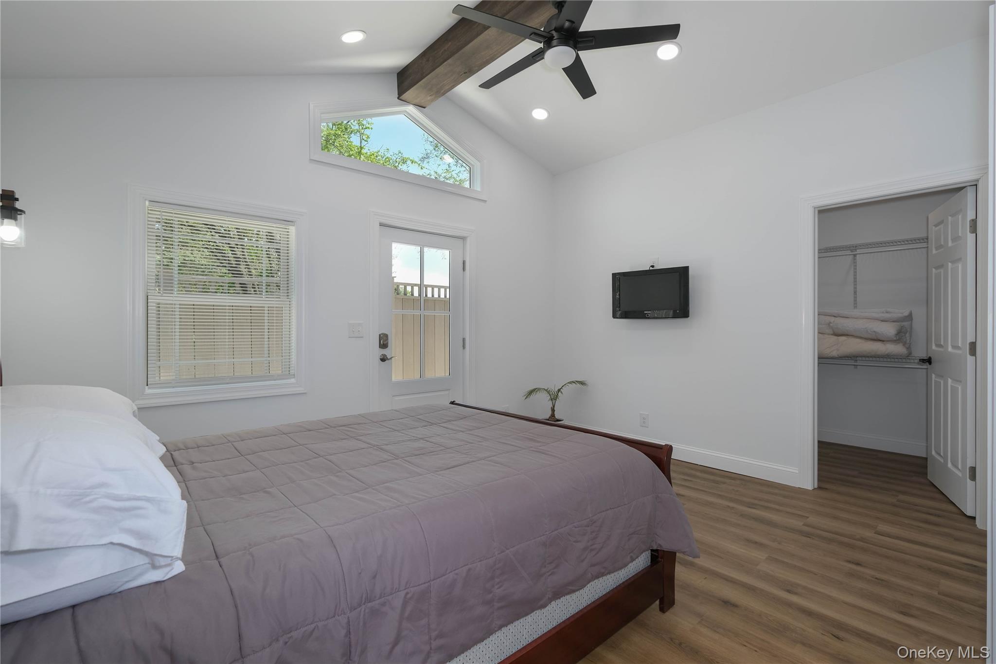 163 Hapeman Hill Road Red Hook, NY 12571 - Photo 44 of 50 Main level bedroom with gleaming floors, a spacious closet, ceiling fan, recessed lighting and direct access to rear fenced patio.