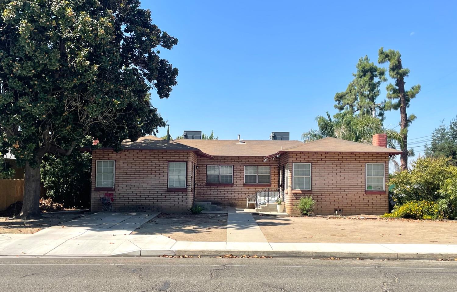 221 North Reed Avenue Reedley, CA 93654 - Photo 1 of 10 a front view of a house with a yard