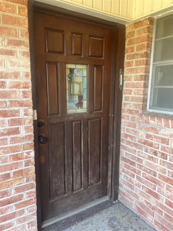 203 Washington Avenue Strawn, TX 76475 - Photo 2 of 20 Doorway to property with brick siding