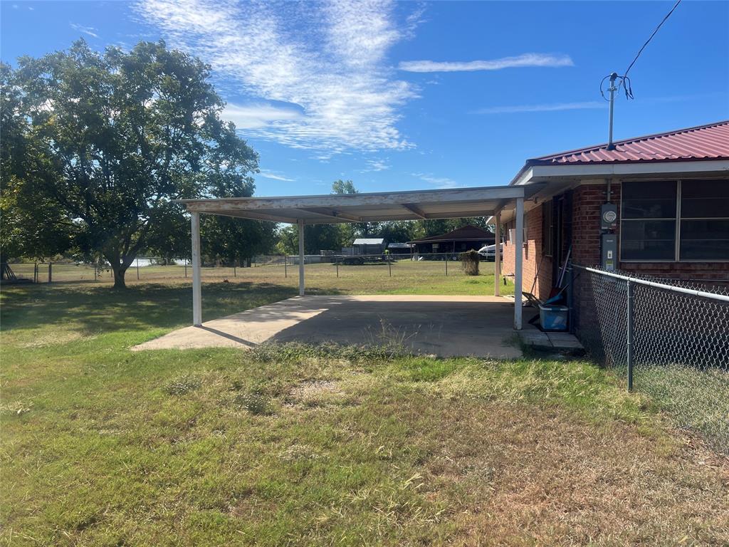 203 Washington Avenue Strawn, TX 76475 - Photo 4 of 20 View of yard featuring an attached carport