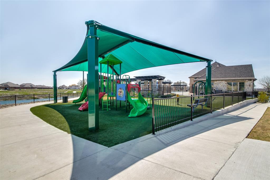 4305 Ridgewood Road Melissa, TX 75454 - Photo 25 of 26 Community playground featuring a shade structure, multiple slides, climbing elements, and artificial turf surfacing