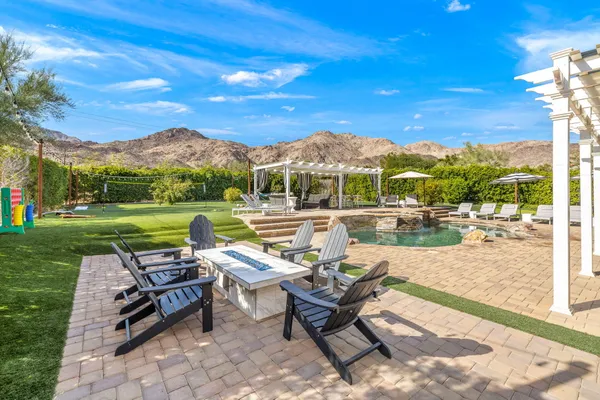 a view of a patio with a table chairs and a backyard