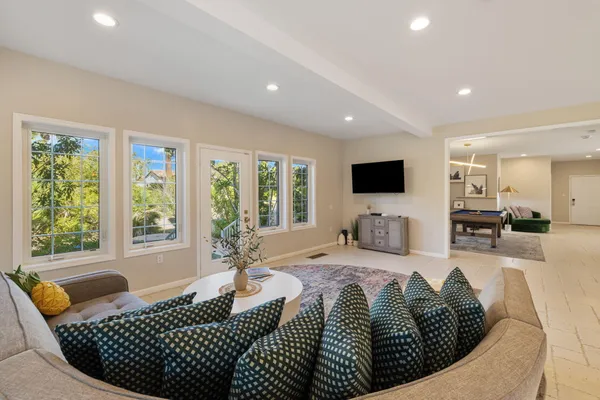 a room with furniture toys and a large window
