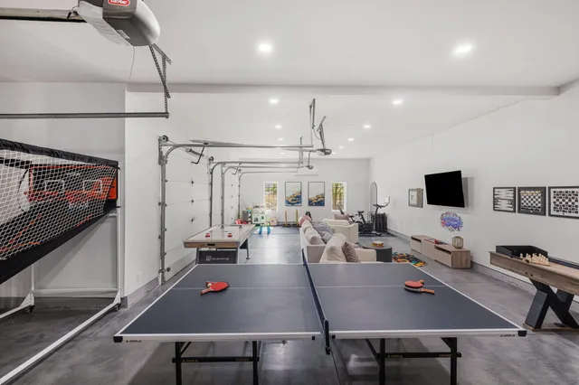 a bedroom with a bed outdoor view and a flat screen tv