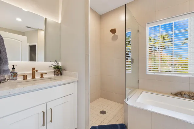 a bedroom with a bed and a large mirror next to a large window