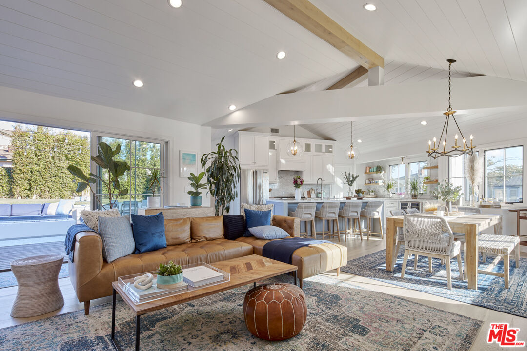 a living room with lots of furniture and a large window