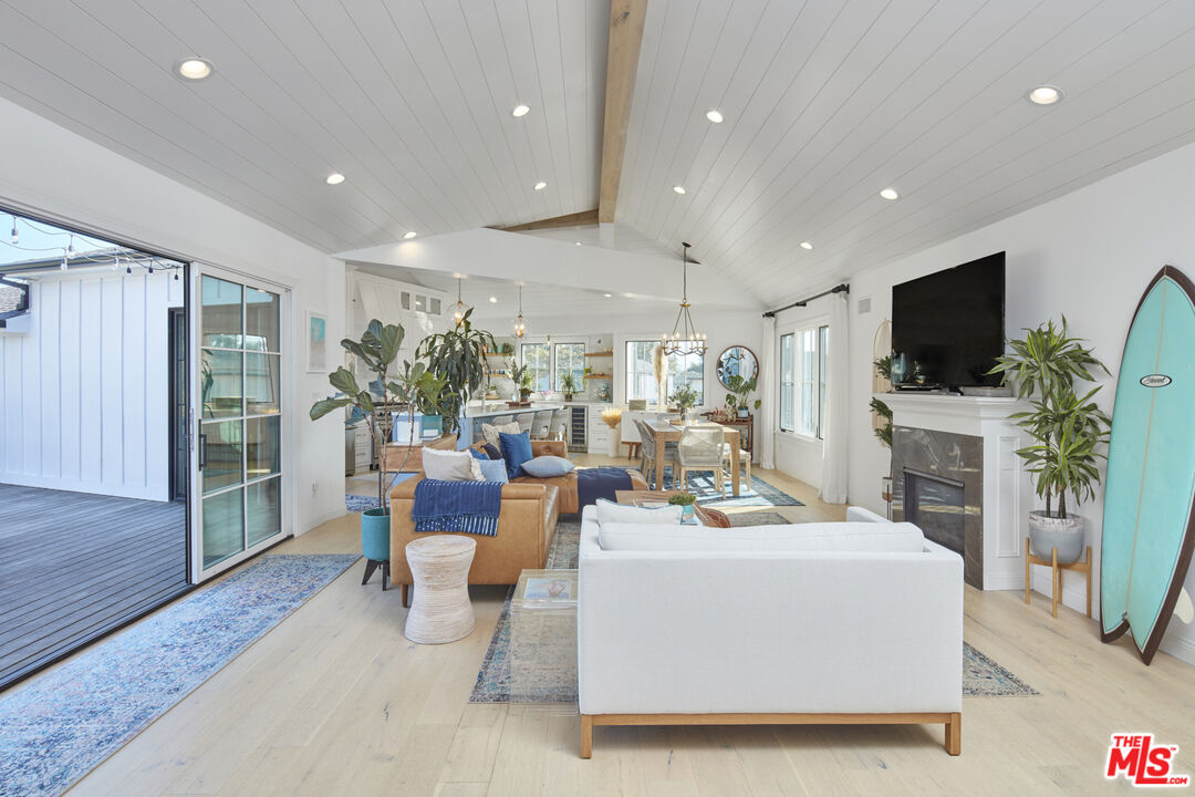 8388 Chase Avenue Los Angeles, CA 90045 - Photo 11 of 30 a living room with furniture a flat screen tv and a fireplace
