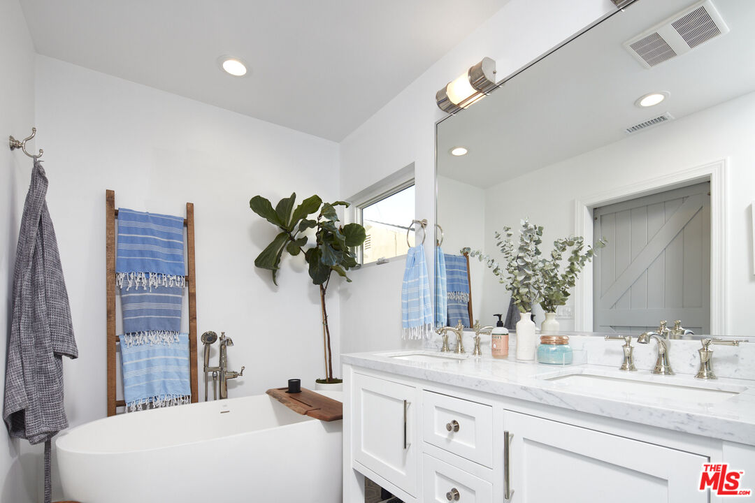 8388 Chase Avenue Los Angeles, CA 90045 - Photo 23 of 30 a bathroom with a double vanity sink and a mirror