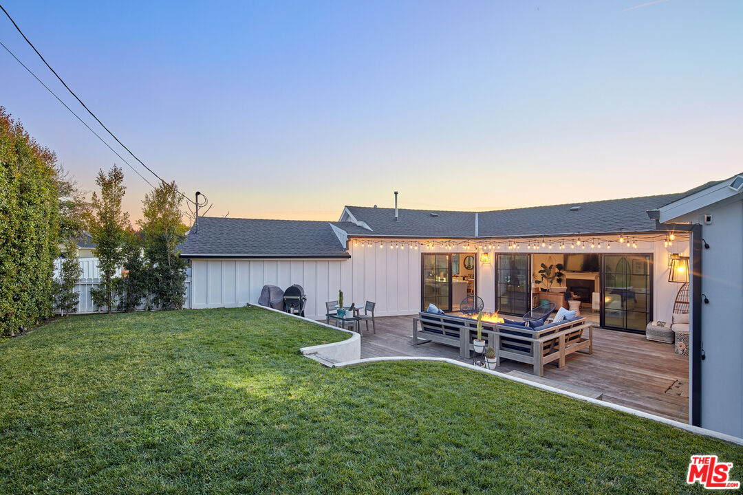 8388 Chase Avenue Los Angeles, CA 90045 - Photo 29 of 30 a view of a backyard with table and chairs with wooden fence