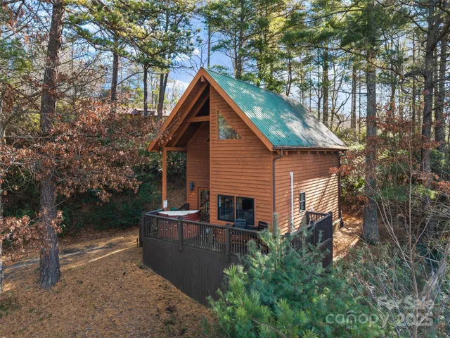 a backyard of a house with wooden fence and large trees