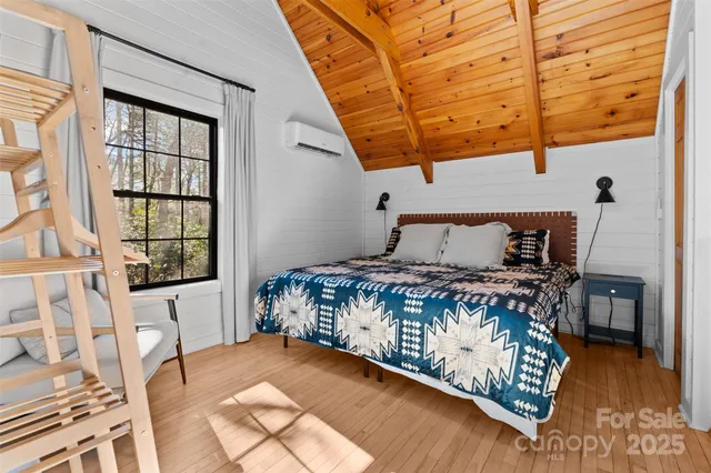 a bed sitting in a bedroom next to a window