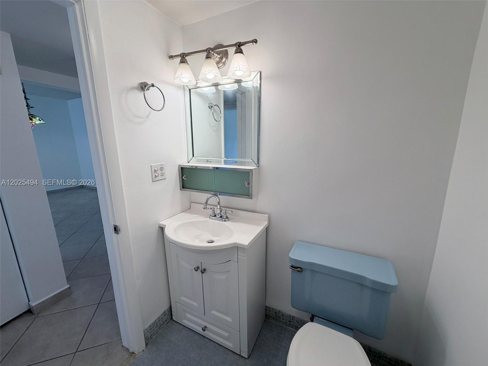 9159 Southwest 77th Avenue, Unit 112 Miami, FL 33156 - Photo 20 of 38 a bathroom with a toilet sink and mirror