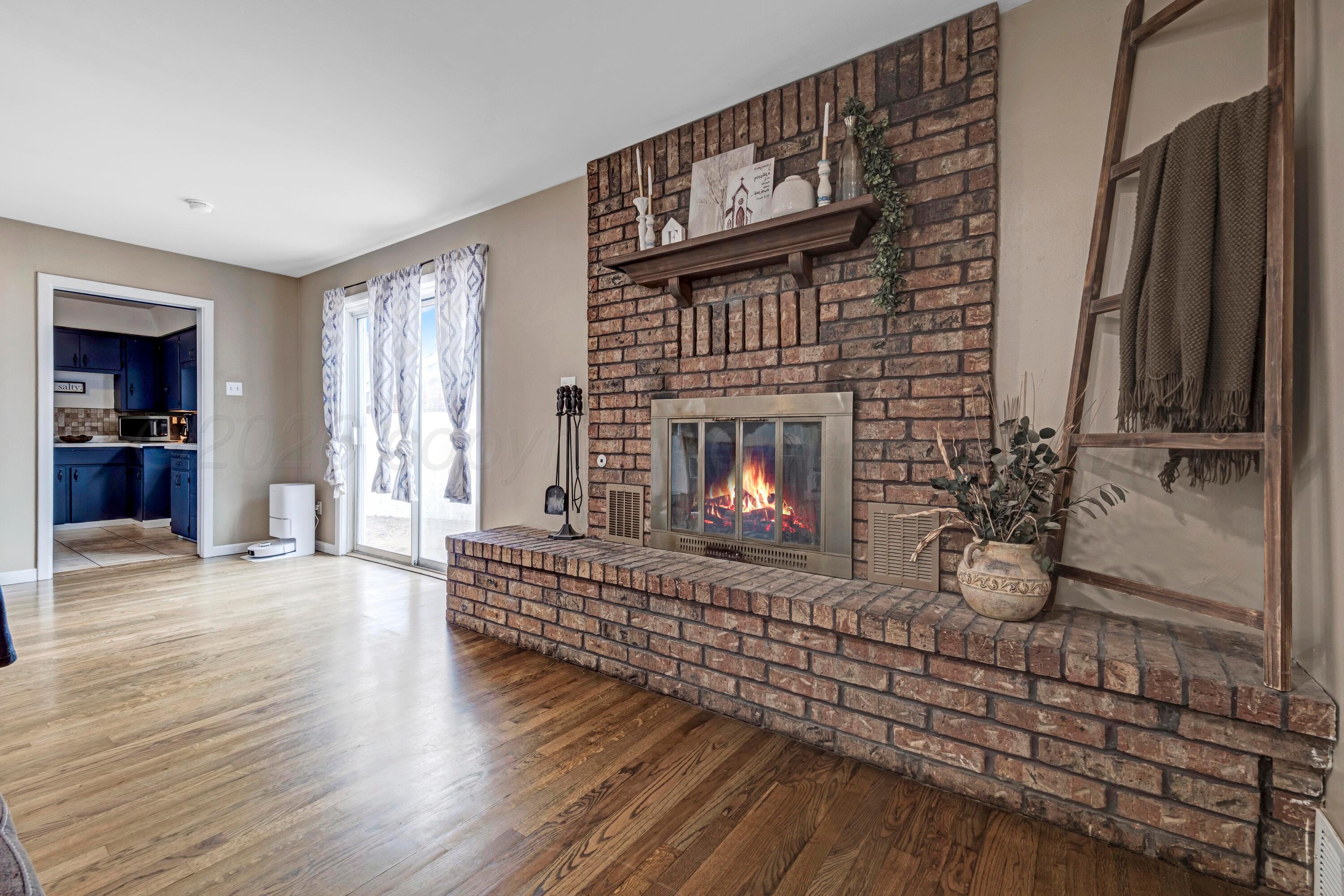 212 Teague Street Borger, TX 79007 - Photo 1 of 30 a living room with furniture a fireplace and a flat screen tv