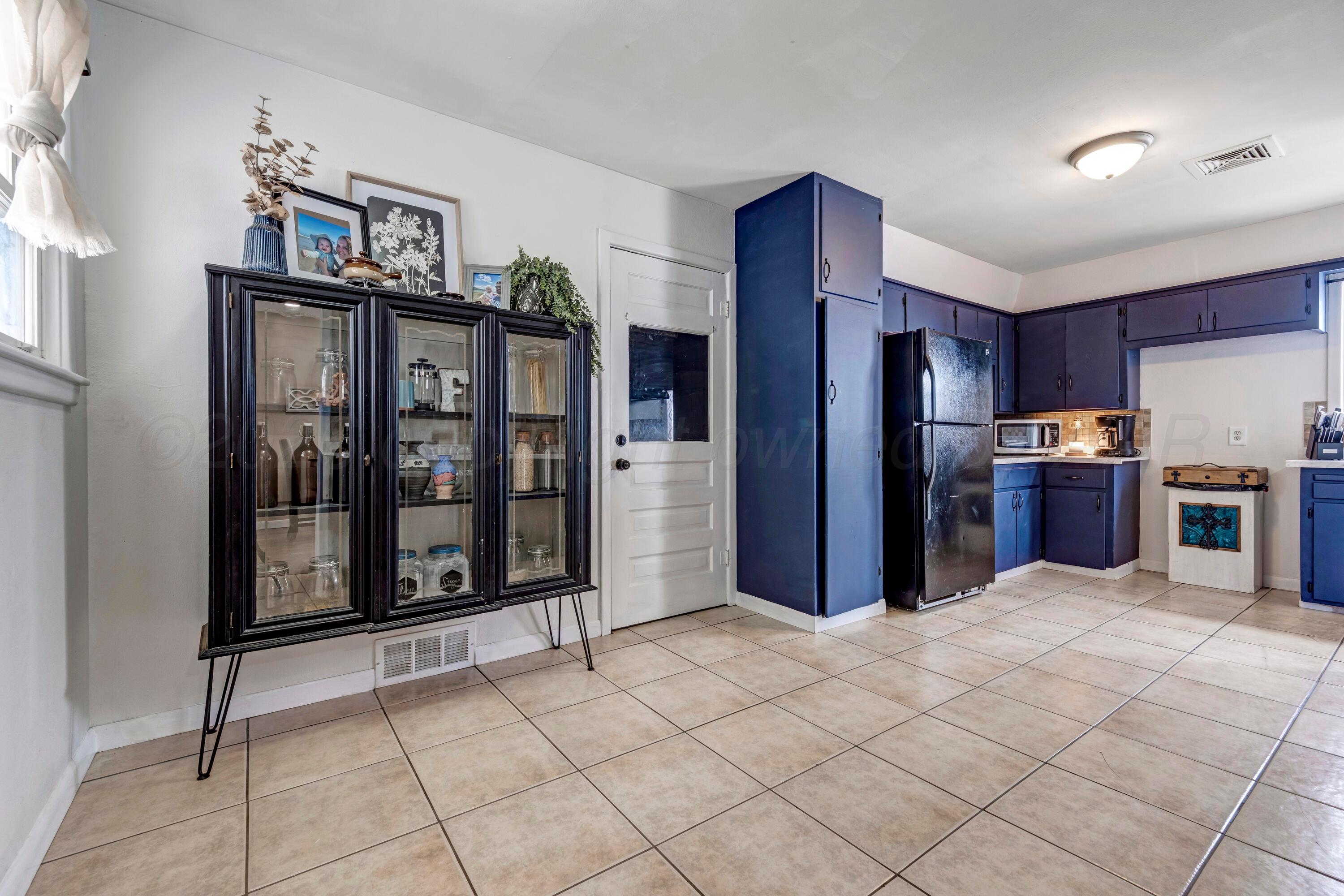 212 Teague Street Borger, TX 79007 - Photo 11 of 30 a kitchen with stainless steel appliances granite countertop a refrigerator and a stove top oven