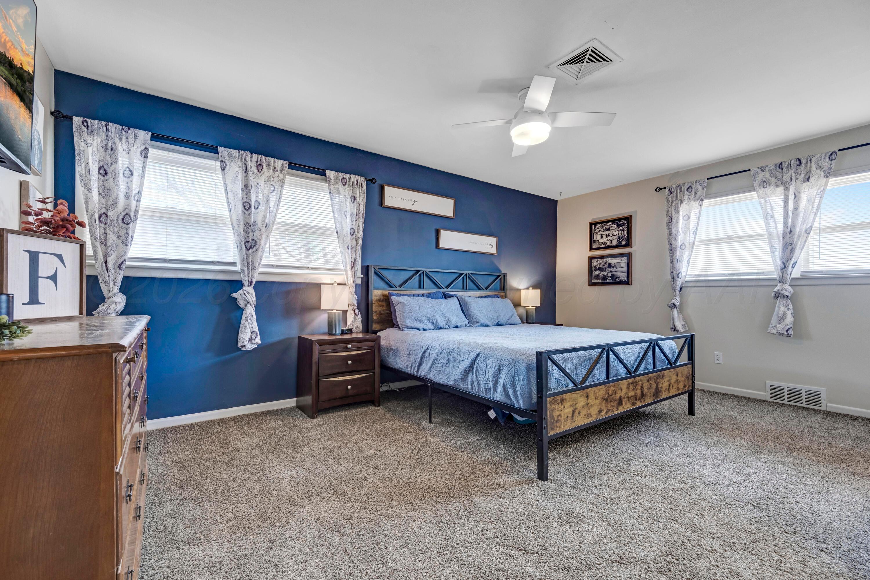 212 Teague Street Borger, TX 79007 - Photo 12 of 30 a bedroom with a large bed and a chandelier