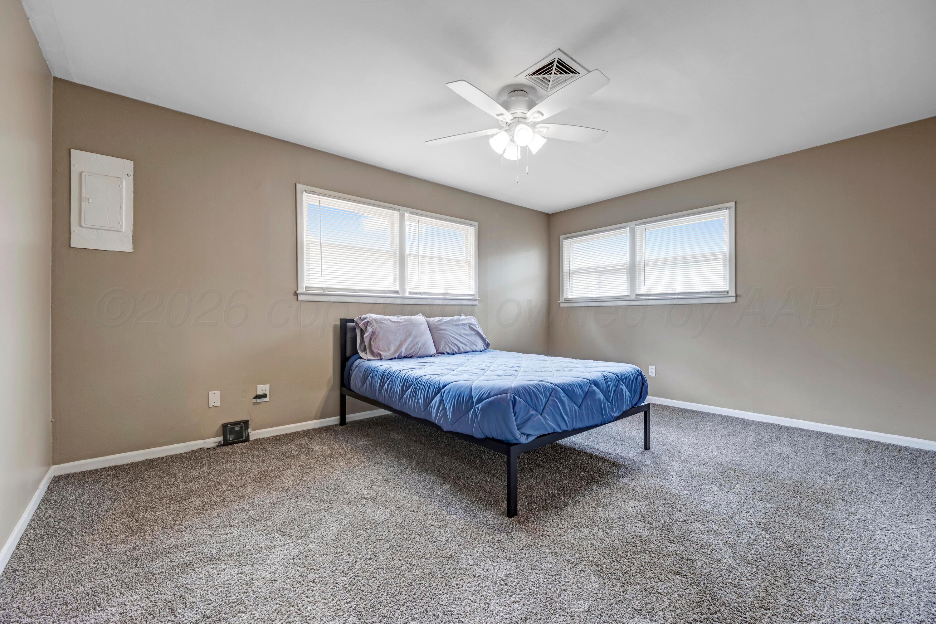 212 Teague Street Borger, TX 79007 - Photo 18 of 30 a spacious bedroom with a bed and window