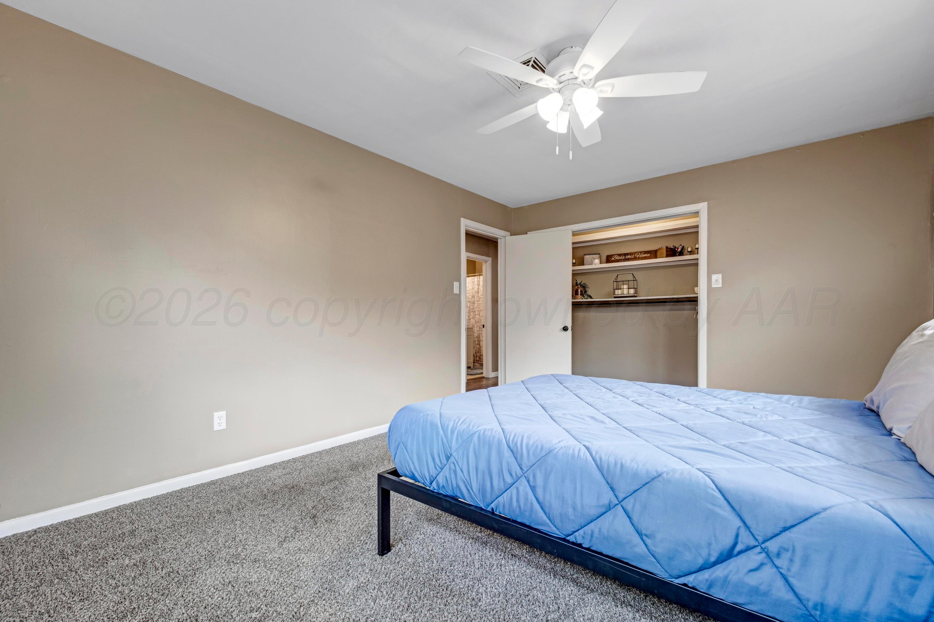 212 Teague Street Borger, TX 79007 - Photo 19 of 30 a bedroom with a bed and a ceiling fan