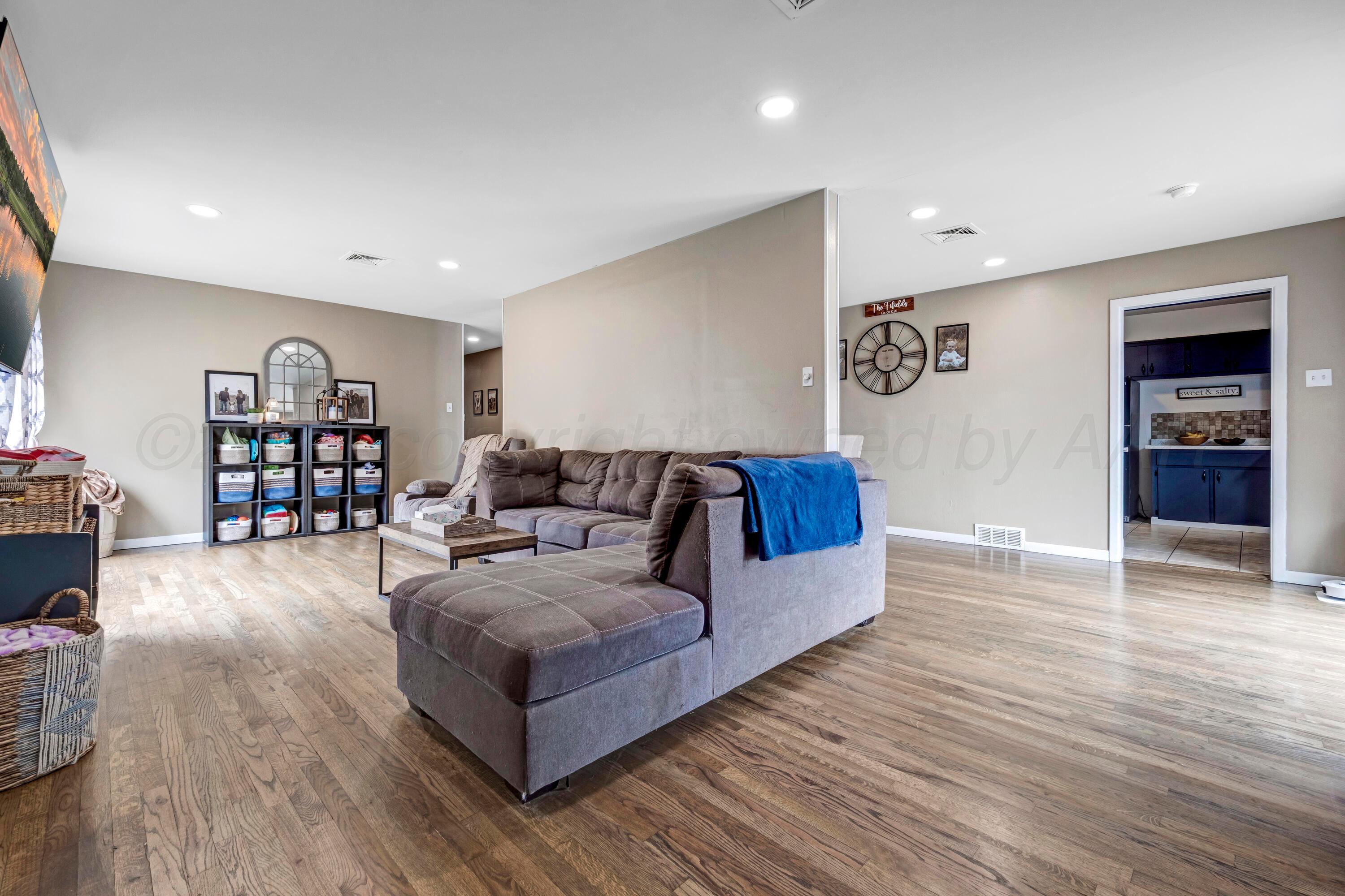 212 Teague Street Borger, TX 79007 - Photo 4 of 30 a living room with furniture and a wooden floor