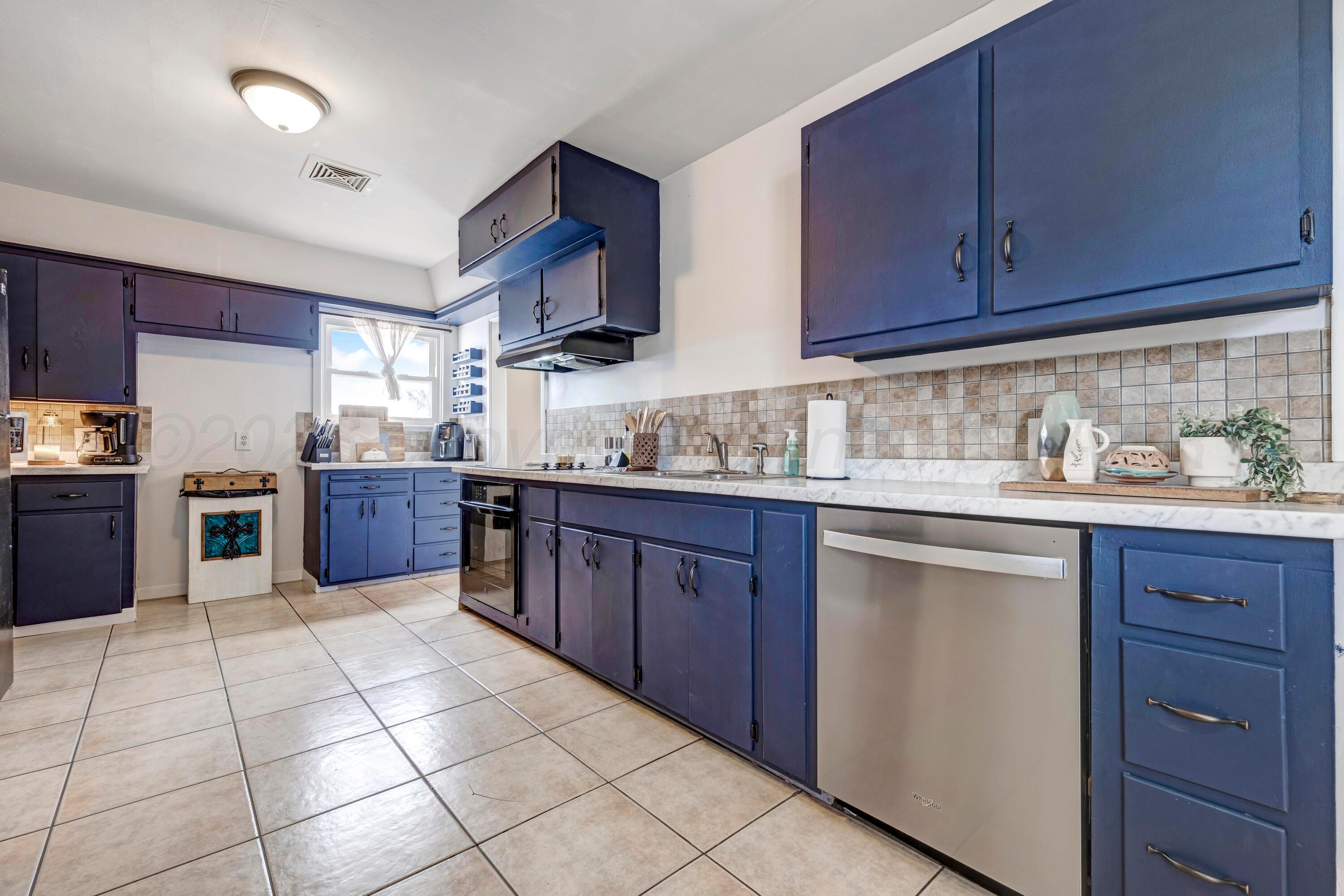 212 Teague Street Borger, TX 79007 - Photo 7 of 30 a kitchen with stainless steel appliances granite countertop a stove sink and cabinets