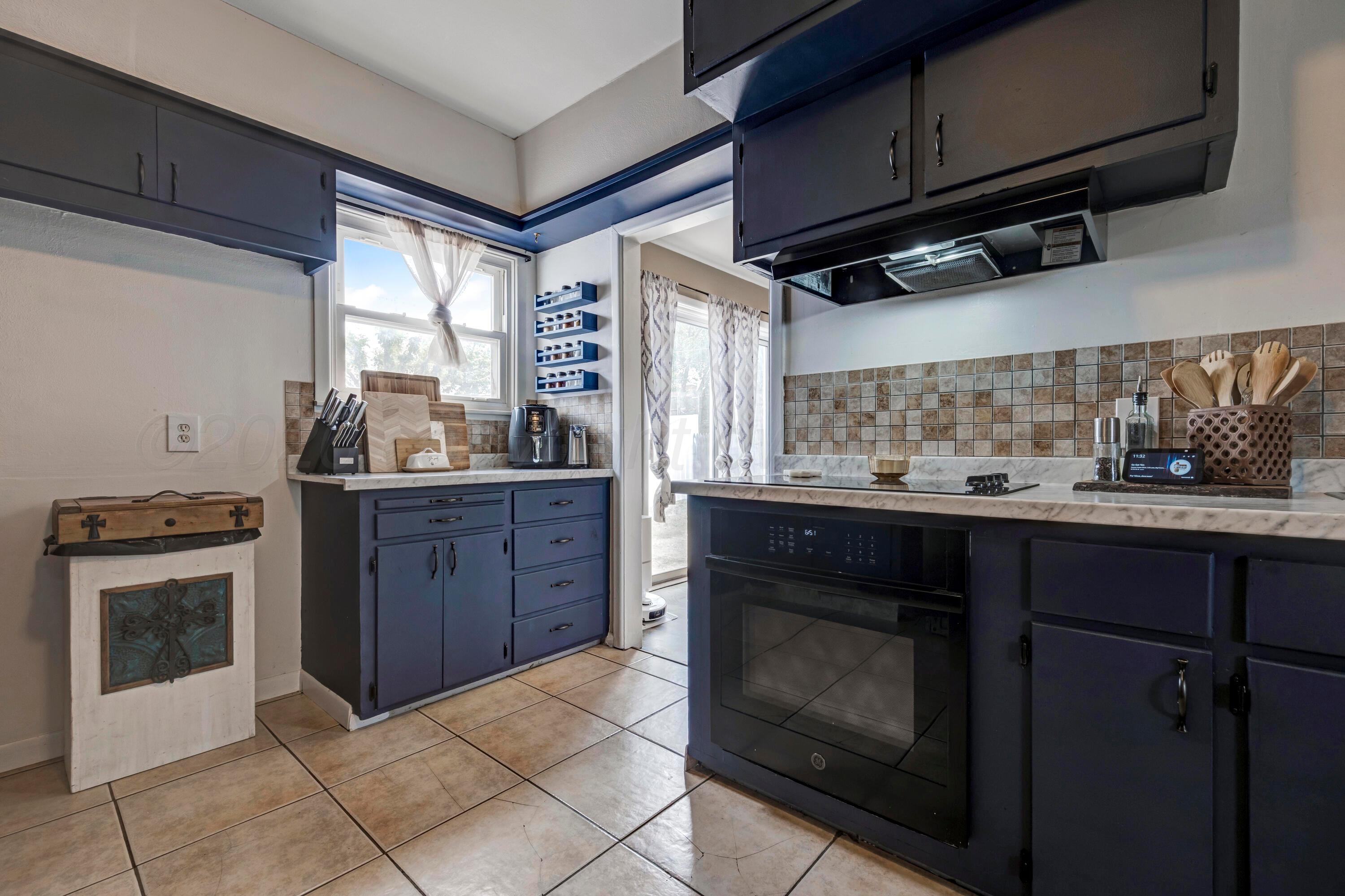 212 Teague Street Borger, TX 79007 - Photo 9 of 30 a kitchen with a stove and a refrigerator