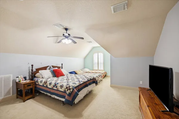 a bedroom with a bed and a chandelier