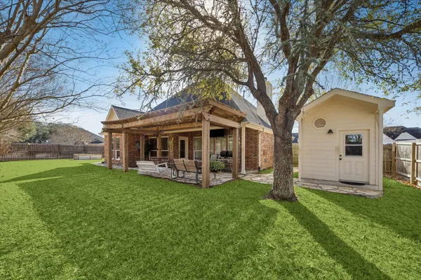 a view of a house with a yard and sitting area